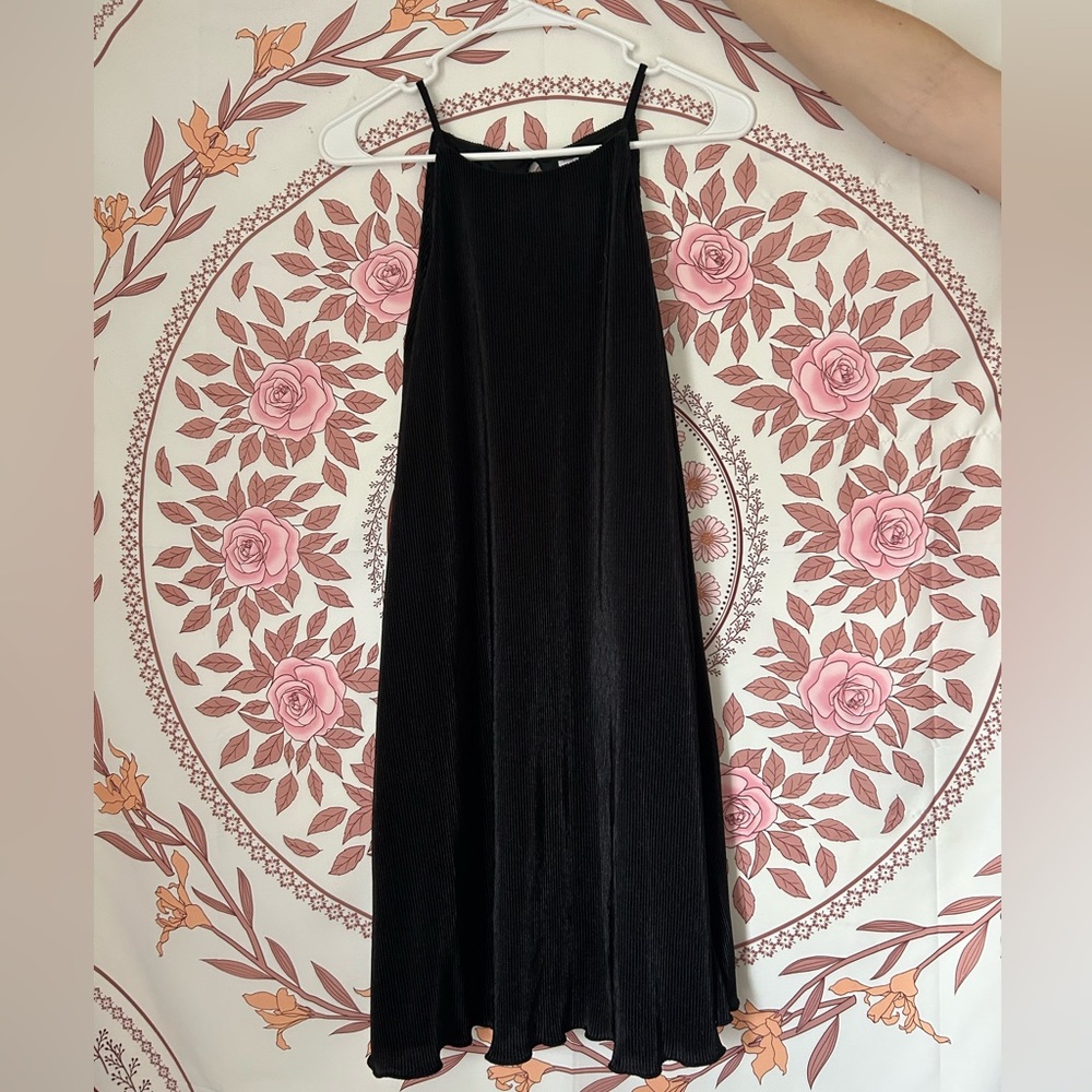 A medium sized, high neck, classic black dress. Ruffled along the bottom. :)